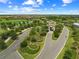 Aerial view of a community entrance featuring lush landscaping, water features and elegant architecture at 17118 Vardon Ter # 404, Bradenton, FL 34211