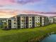 A scenic view of the condo buildings on a lush green property at 17118 Vardon Ter # 404, Bradenton, FL 34211