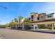 Multi-story condo with covered parking featuring stone accents and lush landscaping at 17118 Vardon Ter # 404, Bradenton, FL 34211
