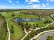 Aerial view of the golf course with ponds, lush green fairways, and beautiful community homes at 17118 Vardon Ter # 404, Bradenton, FL 34211