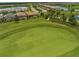 Aerial view of a community situated next to a golf course with lake and residential homes at 17118 Vardon Ter # 404, Bradenton, FL 34211