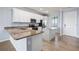 Modern kitchen featuring granite countertops, island, stainless appliances and tile floors at 17118 Vardon Ter # 404, Bradenton, FL 34211