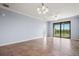 Bright living room with tile flooring and sliding glass doors leading to the balcony at 17118 Vardon Ter # 404, Bradenton, FL 34211
