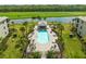 Aerial view of the community pool surrounded by lush landscaping and seating at 17118 Vardon Ter # 404, Bradenton, FL 34211
