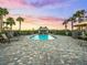 Inviting community pool with palm trees, lounge chairs and a covered area at 17118 Vardon Ter # 404, Bradenton, FL 34211
