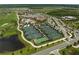 Aerial view of multiple tennis courts surrounded by lush landscaping and part of the community's amenities at 17118 Vardon Ter # 404, Bradenton, FL 34211