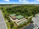 Aerial view of tennis and bocce ball courts surrounded by green space and trees at 17118 Vardon Ter # 404, Bradenton, FL 34211