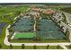 Aerial view of the community tennis courts and surrounding greenery and other facilities at 17118 Vardon Ter # 404, Bradenton, FL 34211