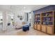 Cozy bedroom with blue accent wall, plush neutral carpet, and open doorway at 17357 Whiskey Creek Trl, Parrish, FL 34219