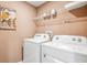 Functional laundry room equipped with modern washer and dryer units and storage at 17357 Whiskey Creek Trl, Parrish, FL 34219