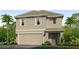 Charming two-story home with a two-car garage, neutral paint, and lush landscaping creating great curb appeal at 17361 Whiskey Creek Trl, Parrish, FL 34219