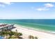 Gorgeous beach and ocean views with condo buildings in the foreground under a sunny blue sky with scattered clouds at 1800 Benjamin Franklin Dr # B1009, Sarasota, FL 34236