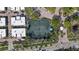 Aerial photo of a tennis court surrounded by lush foliage and community residences on a sunny day at 1800 Benjamin Franklin Dr # B1009, Sarasota, FL 34236