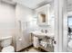 Bathroom featuring a pedestal sink, mirrored medicine cabinet, and modern fixtures at 1800 Benjamin Franklin Dr # B1009, Sarasota, FL 34236