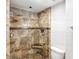 Shower with a glass door and custom stone tiles and in-set storage at 1800 Benjamin Franklin Dr # B1009, Sarasota, FL 34236