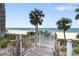 Private beach access via a charming boardwalk, offering stunning views of the ocean and sandy shores at 1800 Benjamin Franklin Dr # B1009, Sarasota, FL 34236