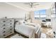 Bright bedroom featuring neutral colors, a comfortable bed, lots of storage, and great natural light at 1800 Benjamin Franklin Dr # B1009, Sarasota, FL 34236