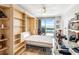 Bedroom with an open built-in bookcase, built-in Murphy bed and a view of the water at 1800 Benjamin Franklin Dr # B1009, Sarasota, FL 34236