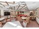 This is a view of the clubhouse area with a large tv, pool table, tables, and chairs at 1800 Benjamin Franklin Dr # B1009, Sarasota, FL 34236