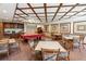A bright, spacious clubhouse area with a pool table and multiple tables with chairs at 1800 Benjamin Franklin Dr # B1009, Sarasota, FL 34236