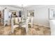 Open dining space with glass top table and modern decor, open to living area at 1800 Benjamin Franklin Dr # B1009, Sarasota, FL 34236