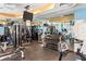 Fully equipped gym with weight machines, free weights, stationary bike, and large mirrors at 1800 Benjamin Franklin Dr # B1009, Sarasota, FL 34236