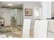 Hallway with art and mirrors that lead to rooms in this home at 1800 Benjamin Franklin Dr # B1009, Sarasota, FL 34236
