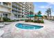 Inviting community hot tub surrounded by mature landscaping, resort amenities and comfortable seating at 1800 Benjamin Franklin Dr # B1009, Sarasota, FL 34236
