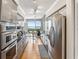 Modern kitchen features stainless steel appliances, sleek gray cabinetry, granite countertops and bright lights at 1800 Benjamin Franklin Dr # B1009, Sarasota, FL 34236