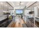 Modern kitchen features stainless steel appliances, sleek gray cabinetry, granite countertops and breakfast nook at 1800 Benjamin Franklin Dr # B1009, Sarasota, FL 34236