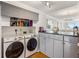 Modern laundry area with front load washer and dryer at 1800 Benjamin Franklin Dr # B1009, Sarasota, FL 34236