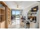 Bright living room features a wall of built-in shelves and sliding glass doors to a balcony with a stunning water view at 1800 Benjamin Franklin Dr # B1009, Sarasota, FL 34236