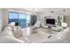 Living room with expansive water view from balcony at 1800 Benjamin Franklin Dr # B1009, Sarasota, FL 34236