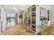 Open-concept living area with custom built-ins and shelving, ocean view at 1800 Benjamin Franklin Dr # B1009, Sarasota, FL 34236