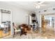 Bright living room features marble floors, modern lighting, and transitions seamlessly to an eat-in kitchen and large built-in bookcase at 1800 Benjamin Franklin Dr # B1009, Sarasota, FL 34236