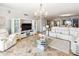 Bright living room showcases modern entertainment center and neutral decor, complementing the marble flooring and open layout at 1800 Benjamin Franklin Dr # B1009, Sarasota, FL 34236