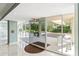Elegant lobby entrance with glass doors and a view of the lush outdoor area at 1800 Benjamin Franklin Dr # B1009, Sarasota, FL 34236