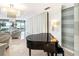 Luxurious lobby with a grand piano, comfortable seating, and ocean views at 1800 Benjamin Franklin Dr # B1009, Sarasota, FL 34236