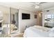 Bright bedroom with ceiling fan, work space and balcony overlooking the water at 1800 Benjamin Franklin Dr # B1009, Sarasota, FL 34236