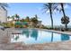 Community pool with lounge seating, lush landscaping, beach access, and other resort style amenities at 1800 Benjamin Franklin Dr # B1009, Sarasota, FL 34236