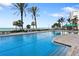 Inviting pool with clear blue water, palm trees, and ocean views, perfect for a refreshing swim at 1800 Benjamin Franklin Dr # B1009, Sarasota, FL 34236