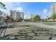 A very well-maintained tennis court available for tenants on a sunny day at 1800 Benjamin Franklin Dr # B1009, Sarasota, FL 34236