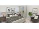 Comfortable bedroom with neutral tones, featuring a large bed, side tables, and a cozy sitting area at 1906 Cobb Trl, Parrish, FL 34219