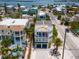 Stunning aerial shot of the home showing its balconies, garage, and proximity to local neighborhood at 2201 Avenue C, Bradenton Beach, FL 34217