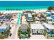 Charming beach house with a private pool and lush tropical landscaping is conveniently located steps from the beach at 2201 Avenue C, Bradenton Beach, FL 34217