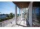 Spacious balcony with spiral staircase, offering views of the neighborhood and a glimpse of the ocean at 2201 Avenue C, Bradenton Beach, FL 34217