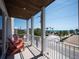 Relaxing balcony with seating and ocean views of palm trees on a clear day at 2201 Avenue C, Bradenton Beach, FL 34217