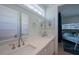 Bright bathroom featuring dual sinks, a white countertop, and a view into bunk room at 2201 Avenue C, Bradenton Beach, FL 34217