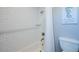 White tiled shower with a seahorse-themed decoration, a toilet and a shower curtain at 2201 Avenue C, Bradenton Beach, FL 34217