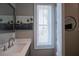 Stylish bathroom featuring a modern vanity with a white countertop and a decorative palm tree painting at 2201 Avenue C, Bradenton Beach, FL 34217